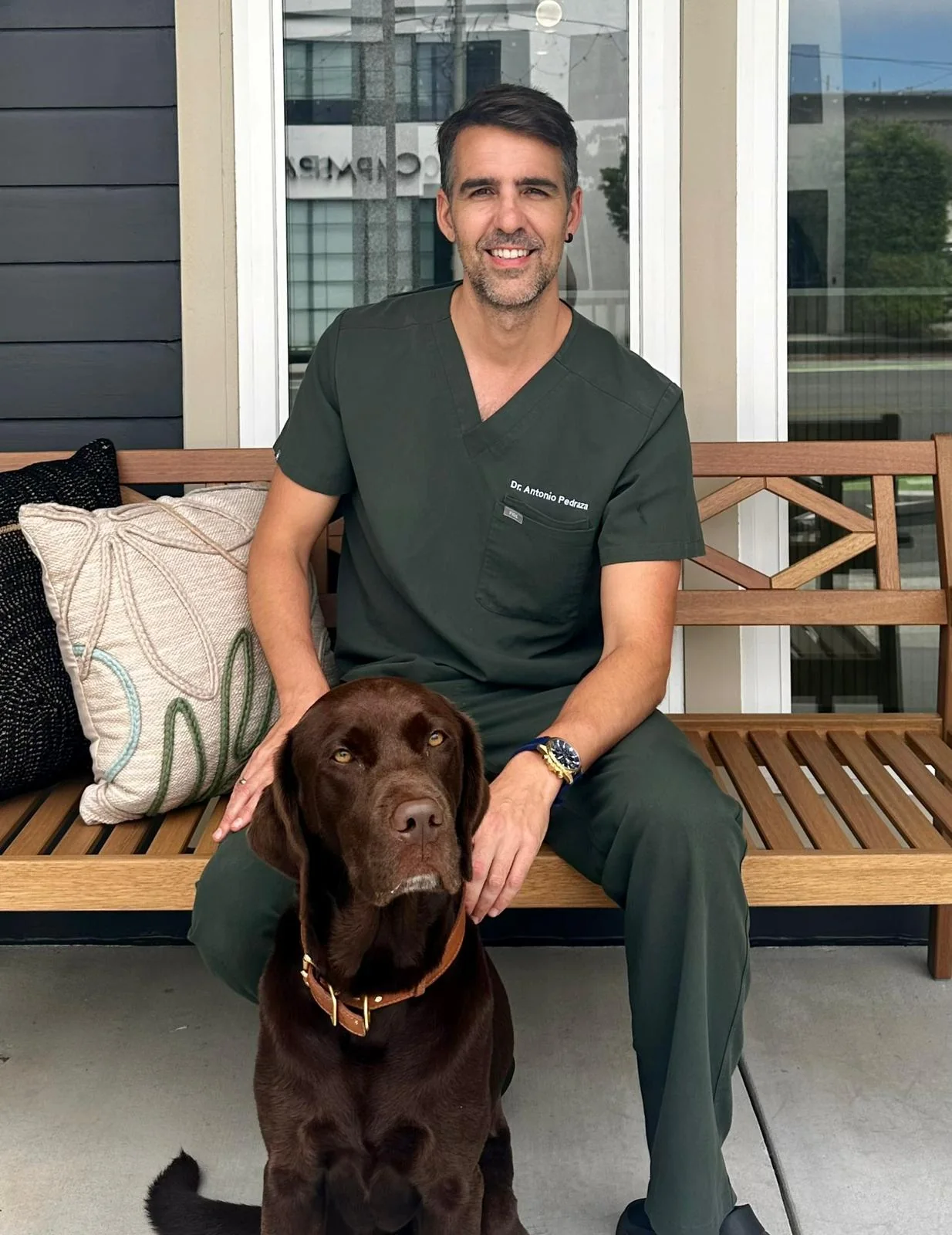 Dr. Antonio Pedraza with a Labrador outside Sevilla Veterinary Hospital in Santa Monica